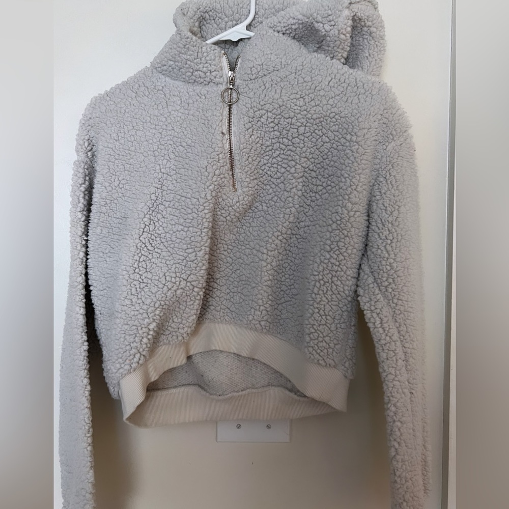This is pure white furry sweater with a hood good for the winter
